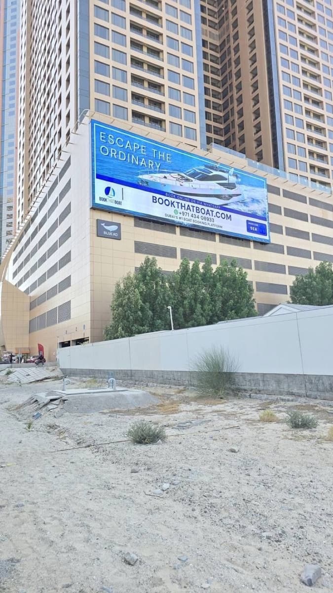 Book That Boat campaign on a WideLoop screen in Dubai, photographed by day