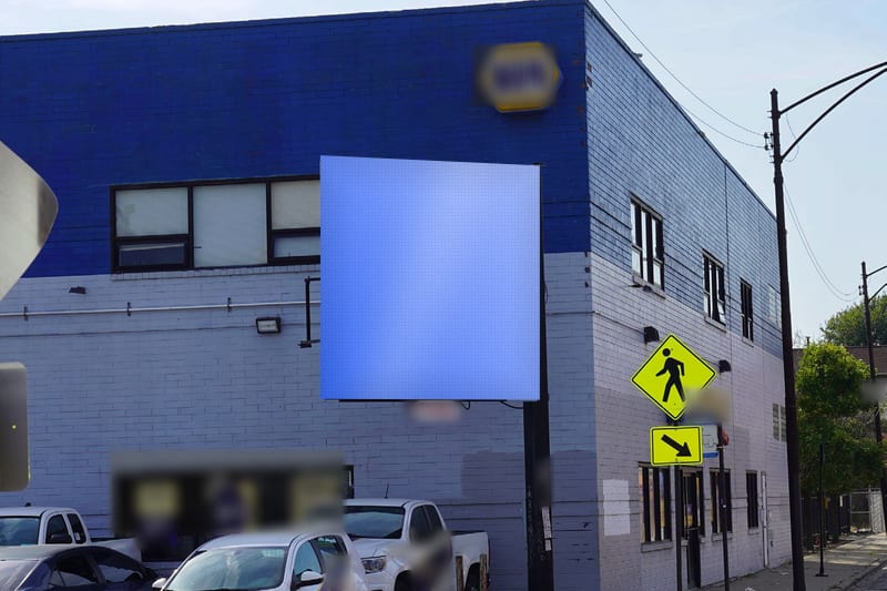 Compact digital screen at Grand Ave at Wolcott Ave · West Town, photographed by day; the advertiser's content is replaced with a preview of your brand