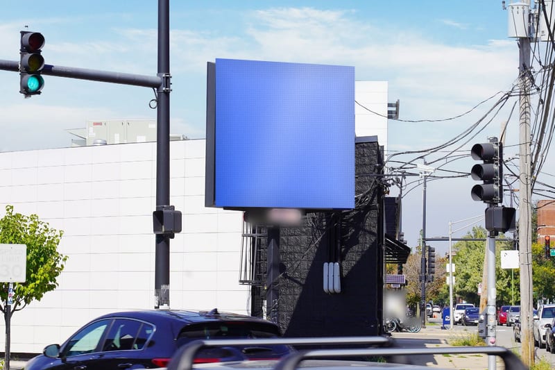 Compact digital screen at Sheffield Ave at Weed St · near North Ave, photographed by day; the advertiser's content is replaced with a preview of your brand